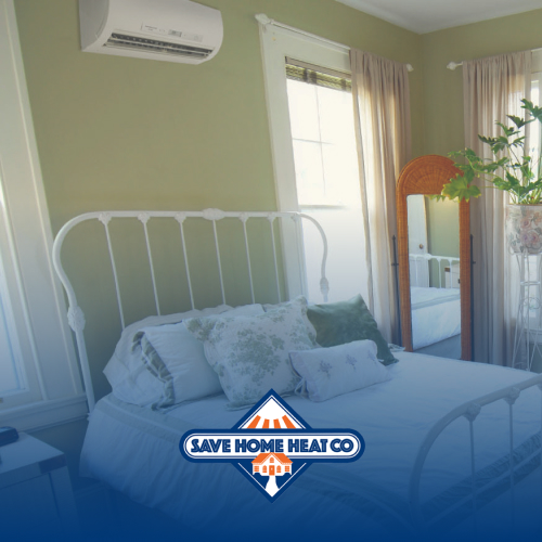 a bedroom with pale green walls showing a ductless unit on a wall