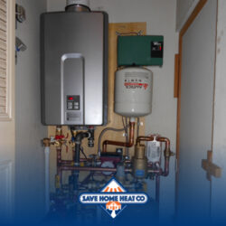 a tankless water heater system with pipes connected to metal units on the wall