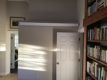 a radiant heating unit along a wall above a home office door