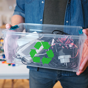 Man holding box of electronics to recycle
