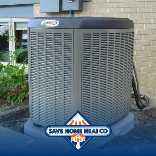 a grey ac unit on a concrete slab next to an exterior brick wall