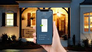 Leviton Decora Smart - phone in hand with outdoor home lighting background