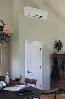 an indoor ductless ac unit on a wall of a living room