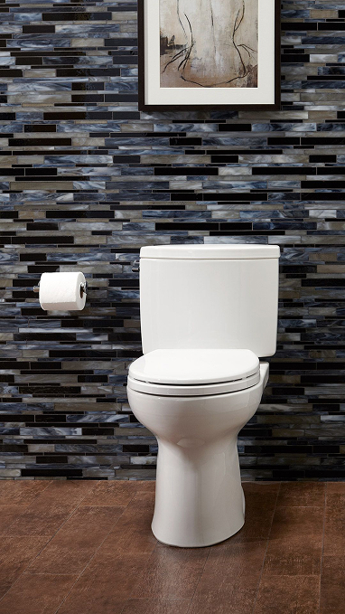 a toilet against a blue tile wall