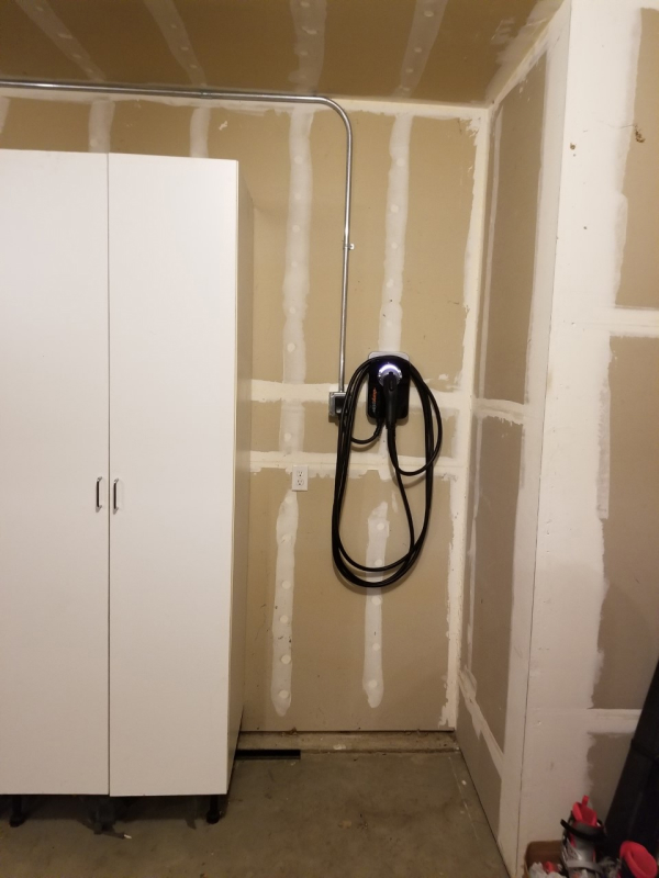 newly installed ev charging station in a garage