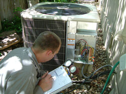 Technician looking at air conditioner