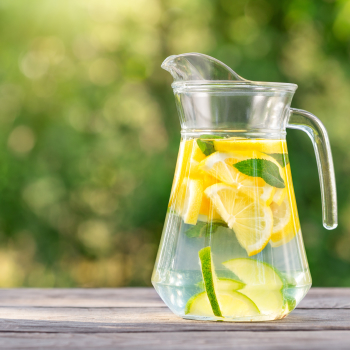 glass water pitcher with lemons in it